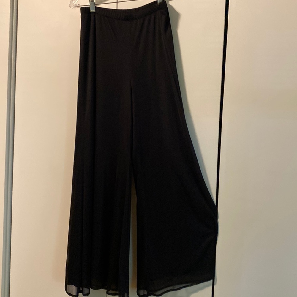 Black pants with tulle overlay.